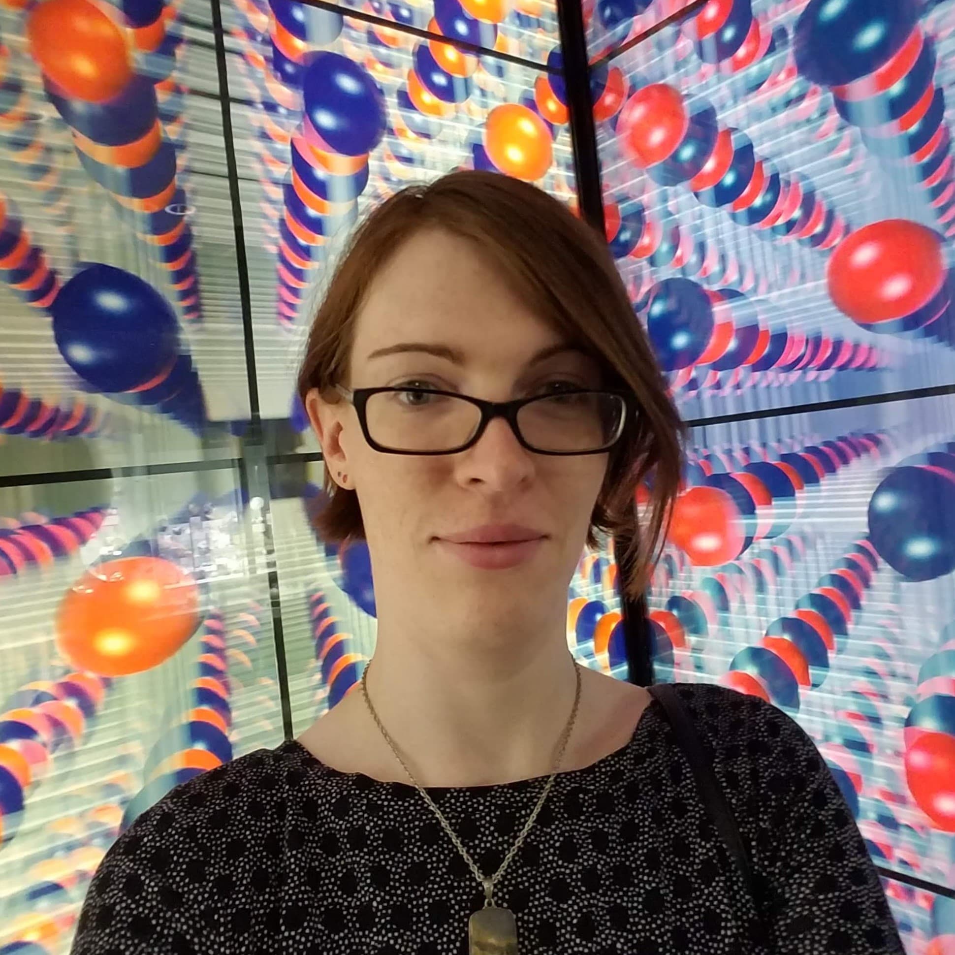 A photo of Hannah in a Smithsonian display of a giant salt molecule